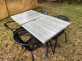 a table and chairs that are outside in the grass