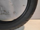 a close up of a tire on a white surface with a white wall in the background