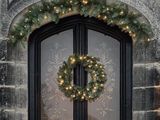 a wreath on the front door of a stone building