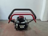 a small lawn mower that is sitting in a room