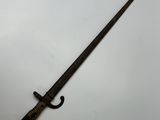 an old sword with a wooden handle on a white surface