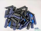 a pile of blue and black wetsuits on a white surface