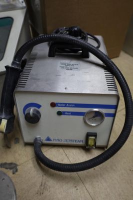a machine that is sitting on the floor next to a monitor