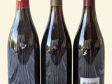 three bottles of wine sitting next to each other on a table
