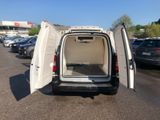 a white van with its doors open in a parking lot