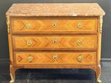 an antique chest of drawers with marble top