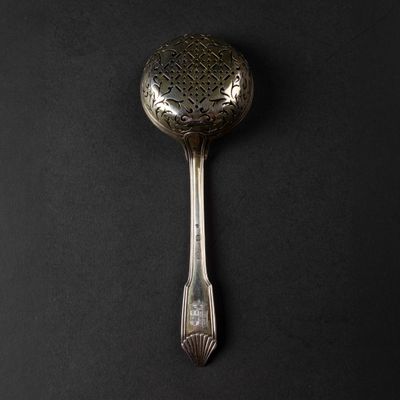 a spoon that is sitting on a black surface