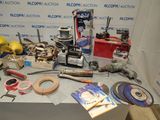 a table with various tools on it in front of a wall