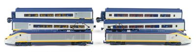 two blue and white double decker trains next to each other