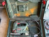 two tools in a green case sitting on the floor