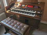 a piano and a bench in the corner of a room