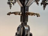 a silver candle holder with a bird on it