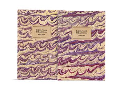 two notebooks are lined up on a white surface with purple and yellow designs