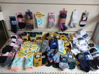 many pairs of socks on a shelf in a store