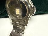 a silver watch that is sitting on a table