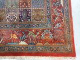 an image of a red rug with a pattern of birds and flowers on it