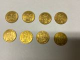 a close up of a bunch of gold coins on a table