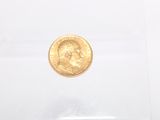 an image of a gold coin sitting on top of a piece of paper