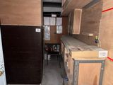 a room that has a bunch of boxes on the shelves
