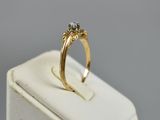 an image of a gold ring with a diamond on it