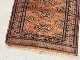 a rug on the floor with a cat sitting on it