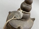 a small statue of a snail with a coin on it ' s back