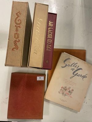 several books are sitting on a white table with a brown cover