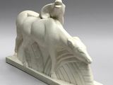 a white sculpture of a horse and a bird on top of it