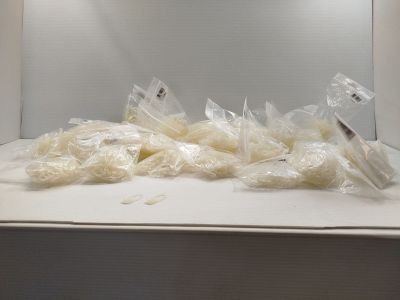 many bags of food sitting on the counter in the microwave