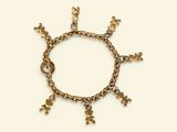 an image of a gold bracelet with flowers on a white background