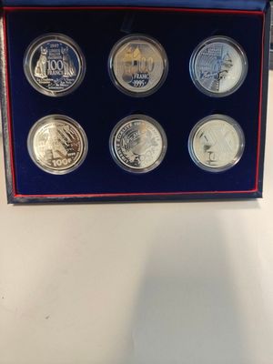 a box of six coins with a picture of a man on it