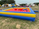 a large inflatable pool with a slider and a slider
