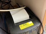 a printer that is sitting on top of a cabinet