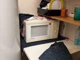 a microwave and a sink in a small room