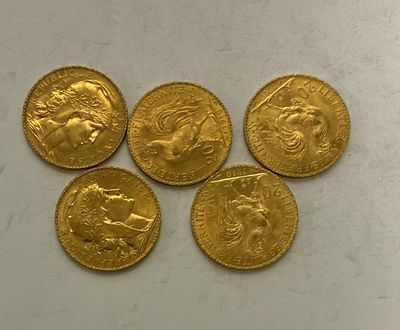 four gold sovereigns of different sizes and shapes on a white surface