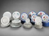a group of porcelain dishes and plates with floral designs on them