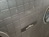 a toilet in a public restroom with a wall mounted urinal
