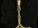 an image of a gold keychain with a crown on it