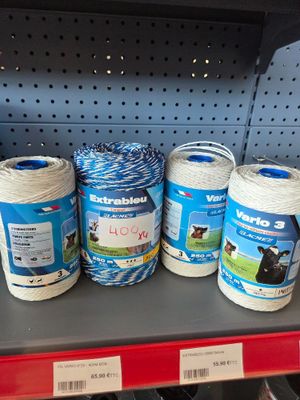 several spools of blue and white yarn are on a shelf