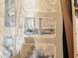 a lot of old photos and papers on a table