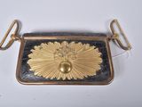gold and black purse with a flower design on the front