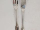 pair of silver plated forks and spoons on a white surface