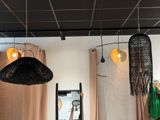 two lamps hanging from the ceiling above a bed
