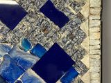 blue and white mosaic tile with a bird on it