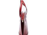 the red leather handbag is open on a white surface