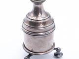 an antique silver plated teapot on a stand on a white background