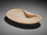 a close up of a bowl on a table with a black background