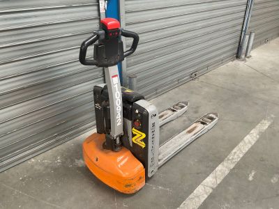 a forklift that is parked in front of a garage door
