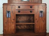 a wooden cabinet with a mirror on top of it