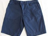 a close up of a pair of shorts laying on a bed